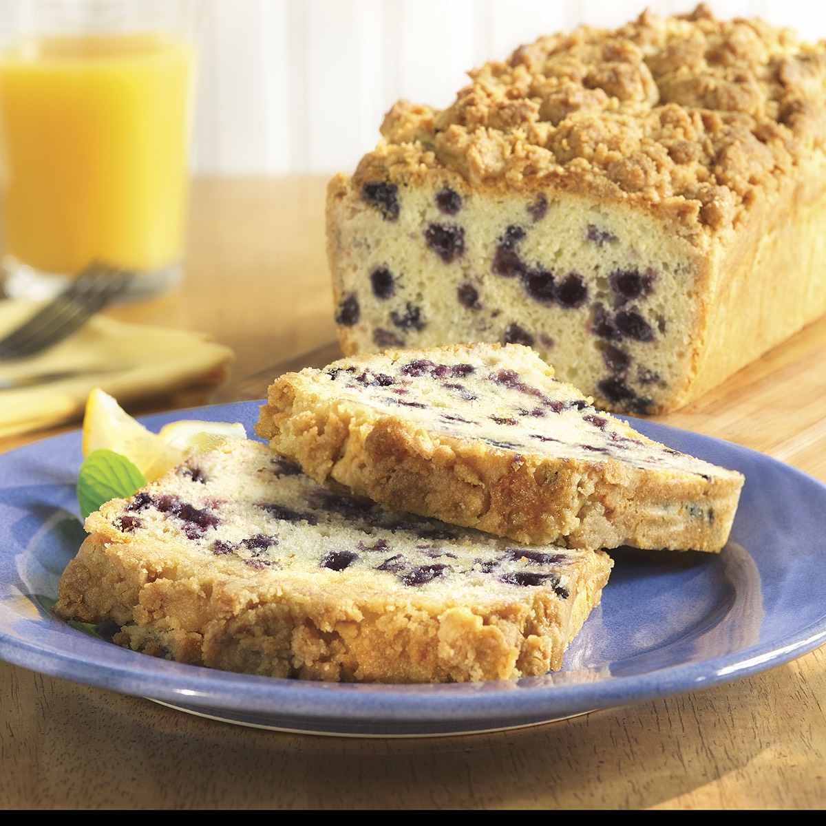 2 slices of Blueberry Crumb Coffee Cake loaf on a plate