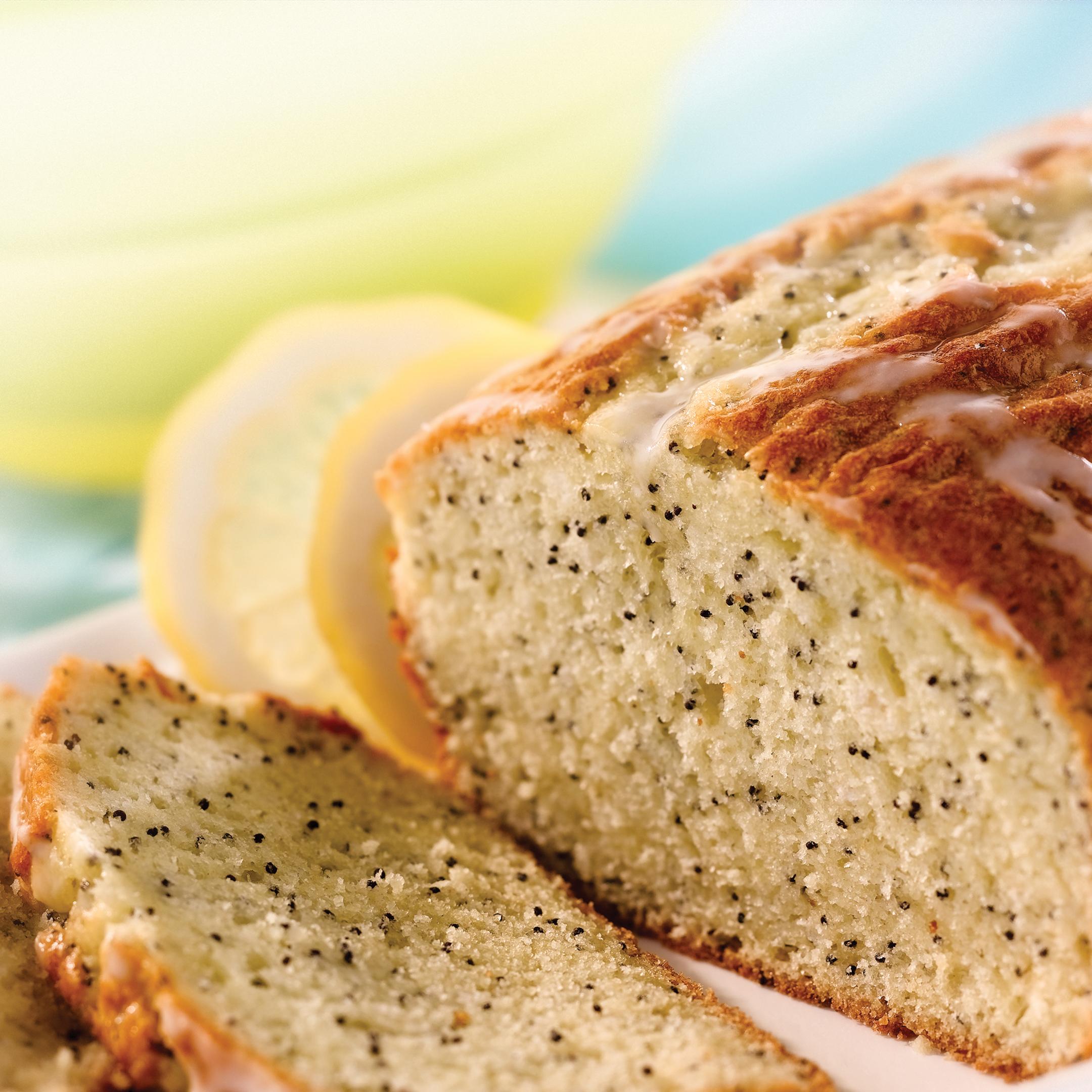 Loaf of lemon poppy seed sliced on a plate